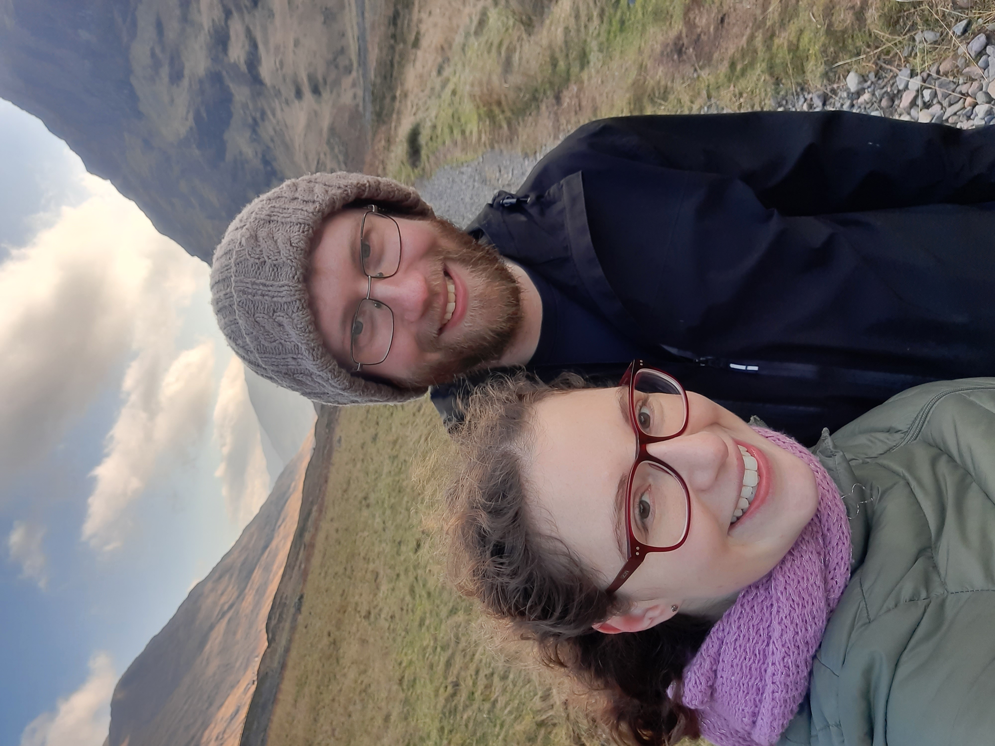 Katelyn and Geoff hiking in Skye, with a valley behind them